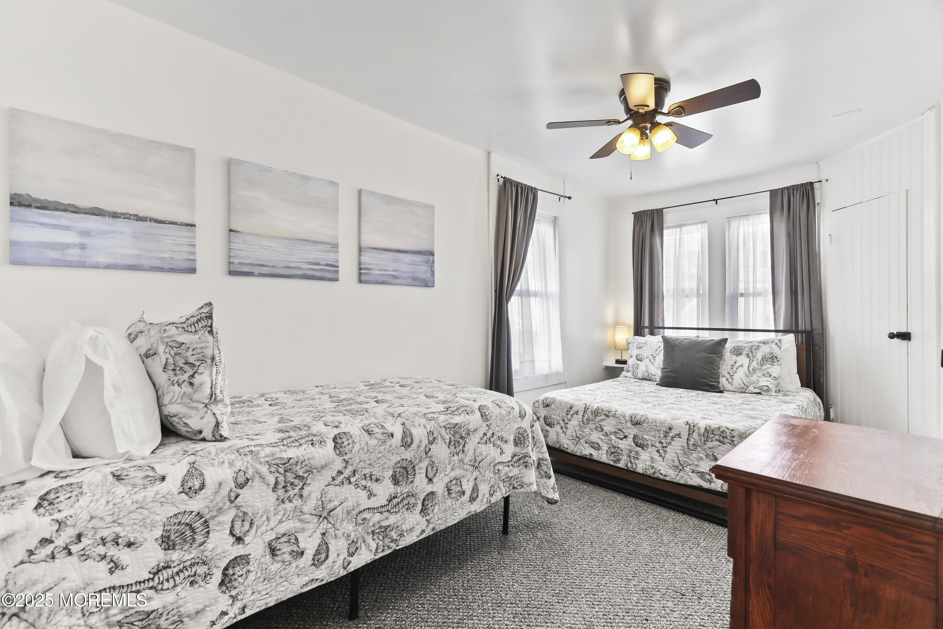 9 Pitman Avenue Ocean Grove, NJ 07756 - Photo 32 of 41 a bedroom with a bed and a chandelier