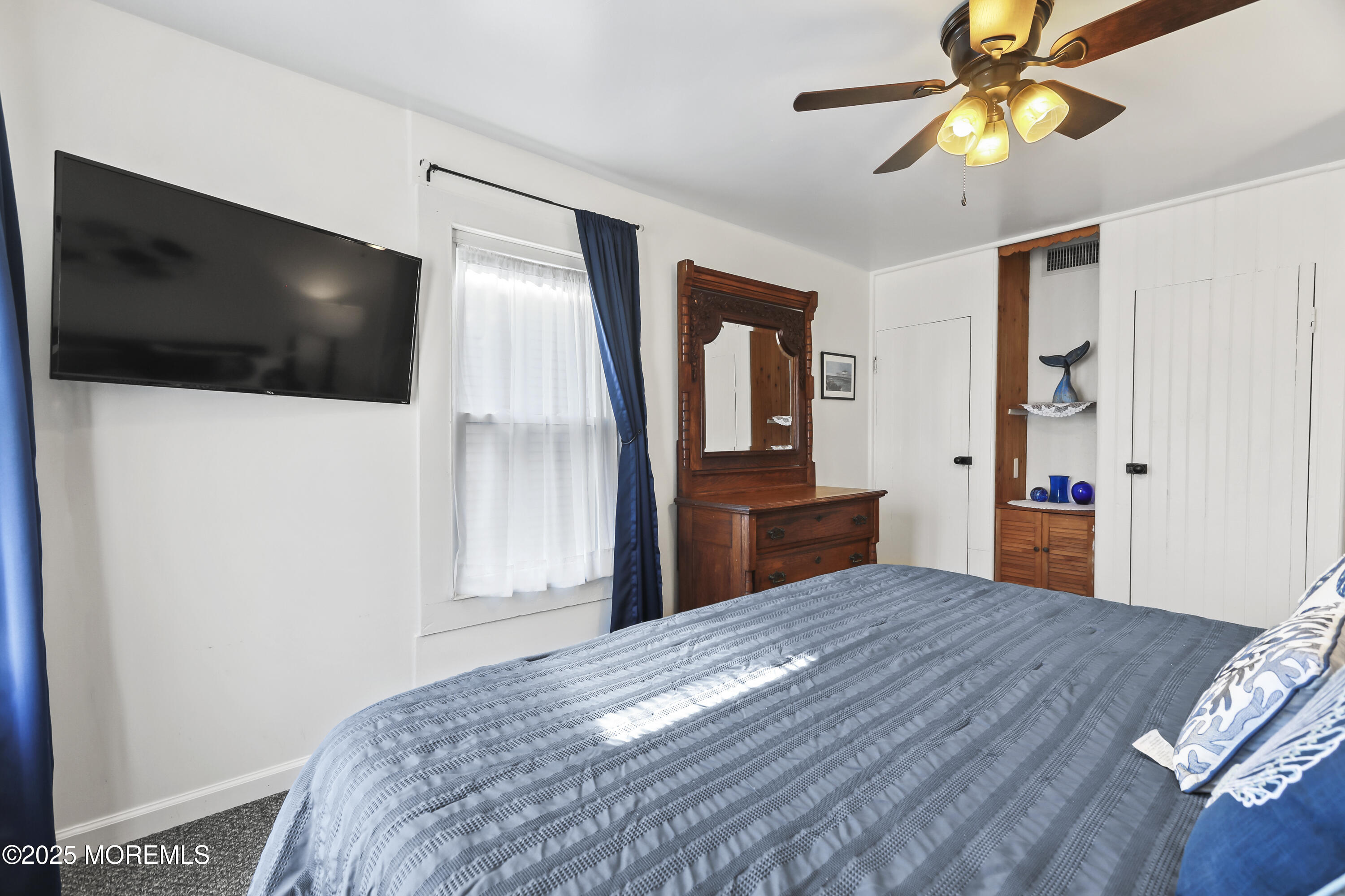 9 Pitman Avenue Ocean Grove, NJ 07756 - Photo 34 of 41 a bedroom with a bed and a chandelier