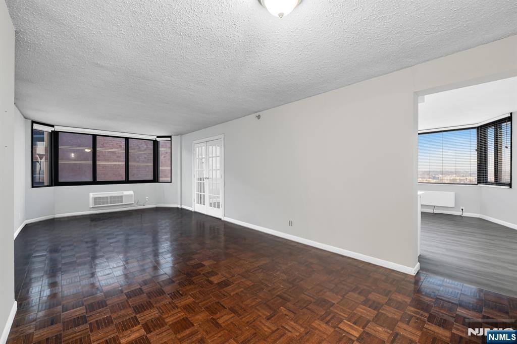 326 Prospect Avenue, Unit 8E Hackensack, NJ 07601 - Photo 13 of 20 wooden floor in an empty room with a window