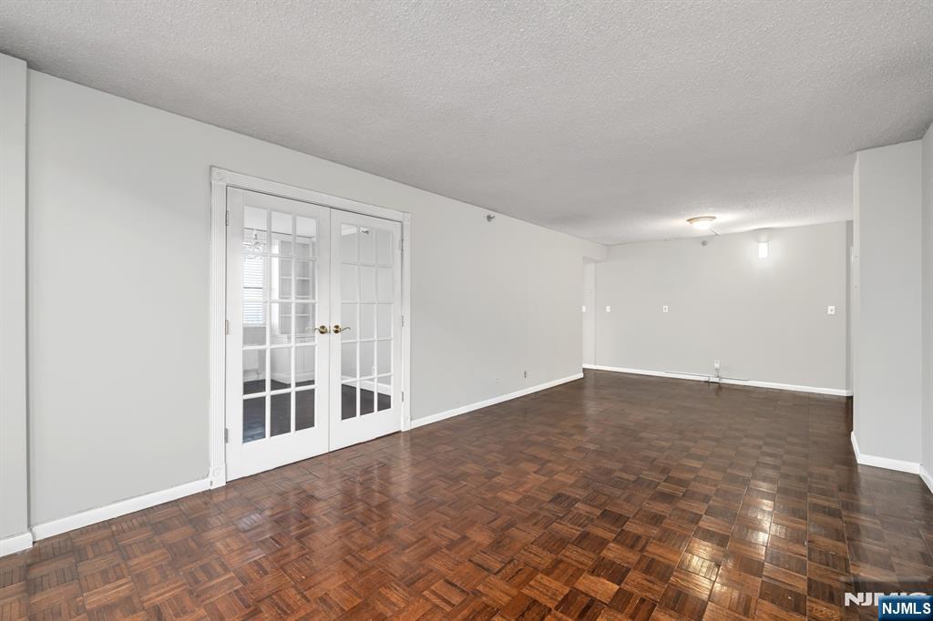 326 Prospect Avenue, Unit 8E Hackensack, NJ 07601 - Photo 15 of 20 a view of an empty room with wooden floor and a window