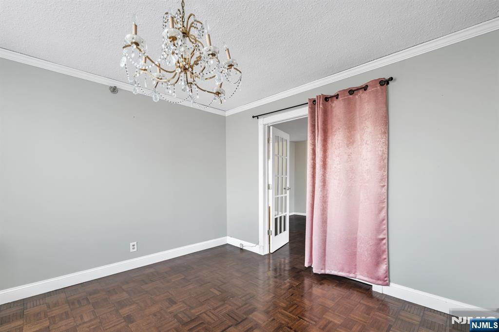 326 Prospect Avenue, Unit 8E Hackensack, NJ 07601 - Photo 18 of 20 a view of a room with a large window and chandelier fan