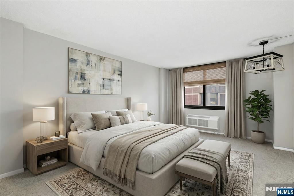 326 Prospect Avenue, Unit 8E Hackensack, NJ 07601 - Photo 6 of 20 a bedroom with a large bed and a chandelier