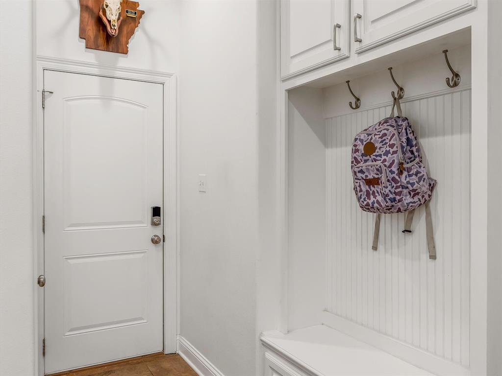 690 Lessie Drive Stonewall, LA 71078 - Photo 14 of 29 Mudroom featuring built-in white cabinetry, beadboard backing, storage hooks, and a bench