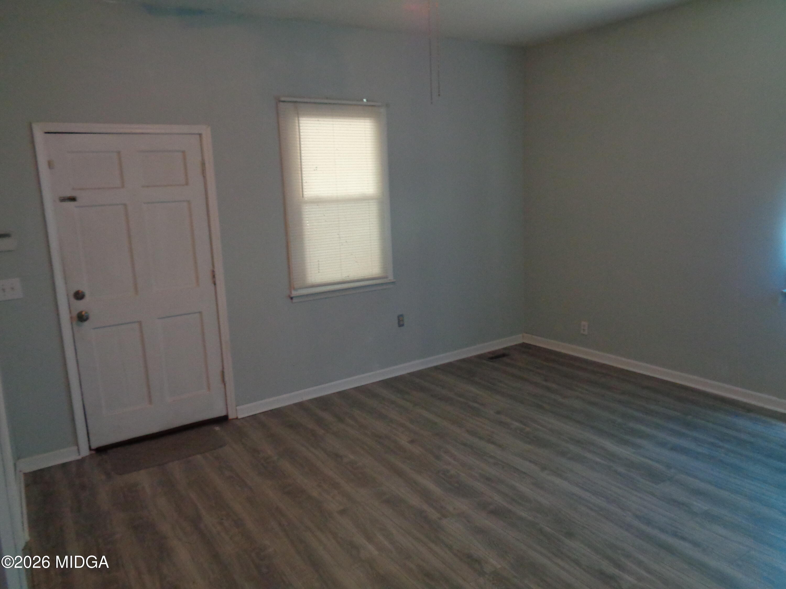 3380 Goodwin Lane Macon, GA 31217 - Photo 14 of 22 an empty room with wooden floor and windows