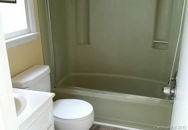 4102 South New Hope Road Gastonia, NC 28056 - Photo 9 of 10 a white toilet and tub sitting next to a window