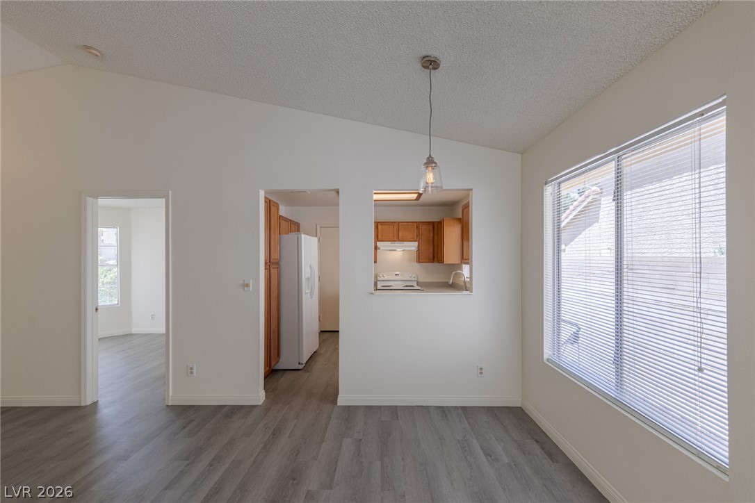 2803 Mirage Road Henderson, NV 89074 - Photo 13 of 39 Vaulted ceilings and wood-look flooring enhance this inviting dining area adjacent to the kitchen.