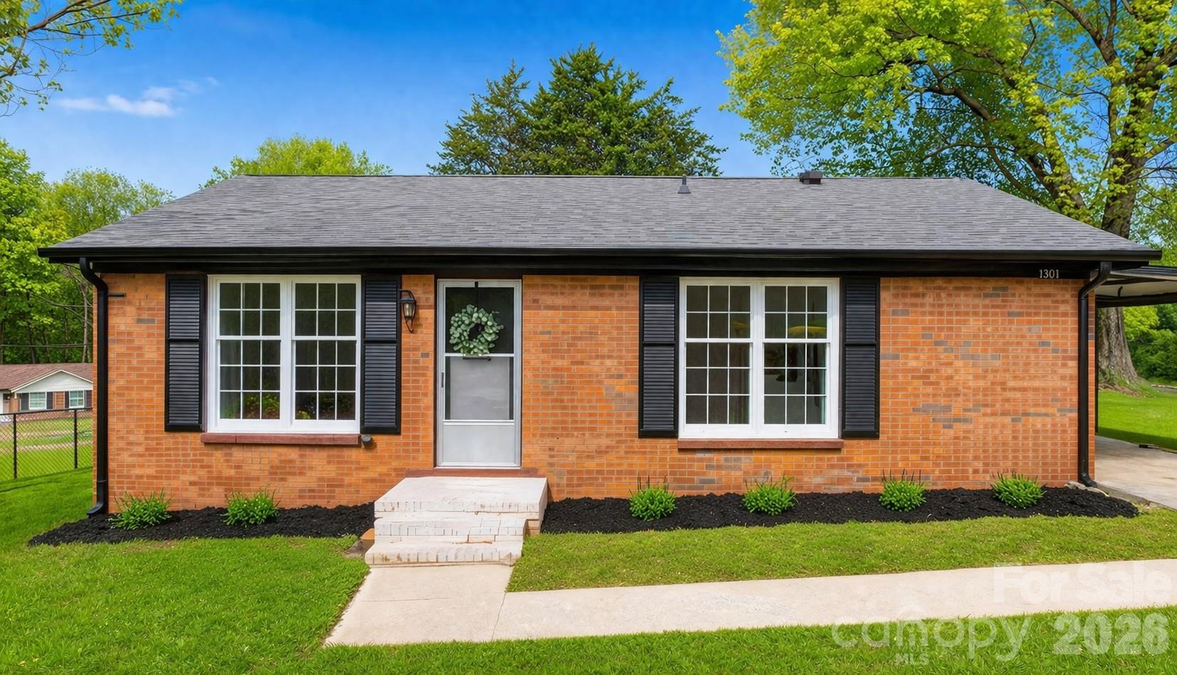 1307 6th Avenue Northwest Conover, NC 28613 - Photo 1 of 17 a front view of a house with a yard