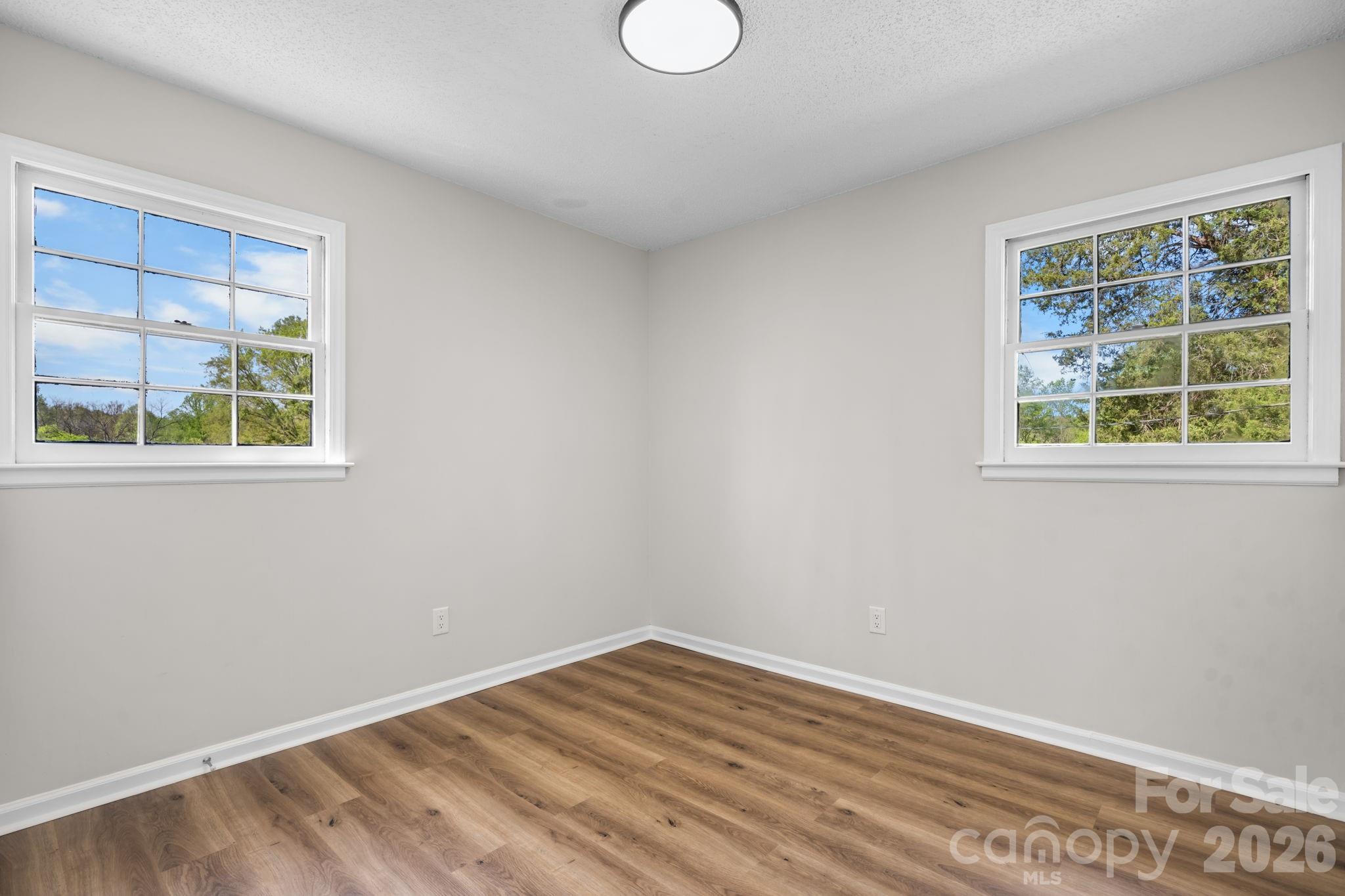 1307 6th Avenue Northwest Conover, NC 28613 - Photo 11 of 17 a view of empty room with wooden floor and fan