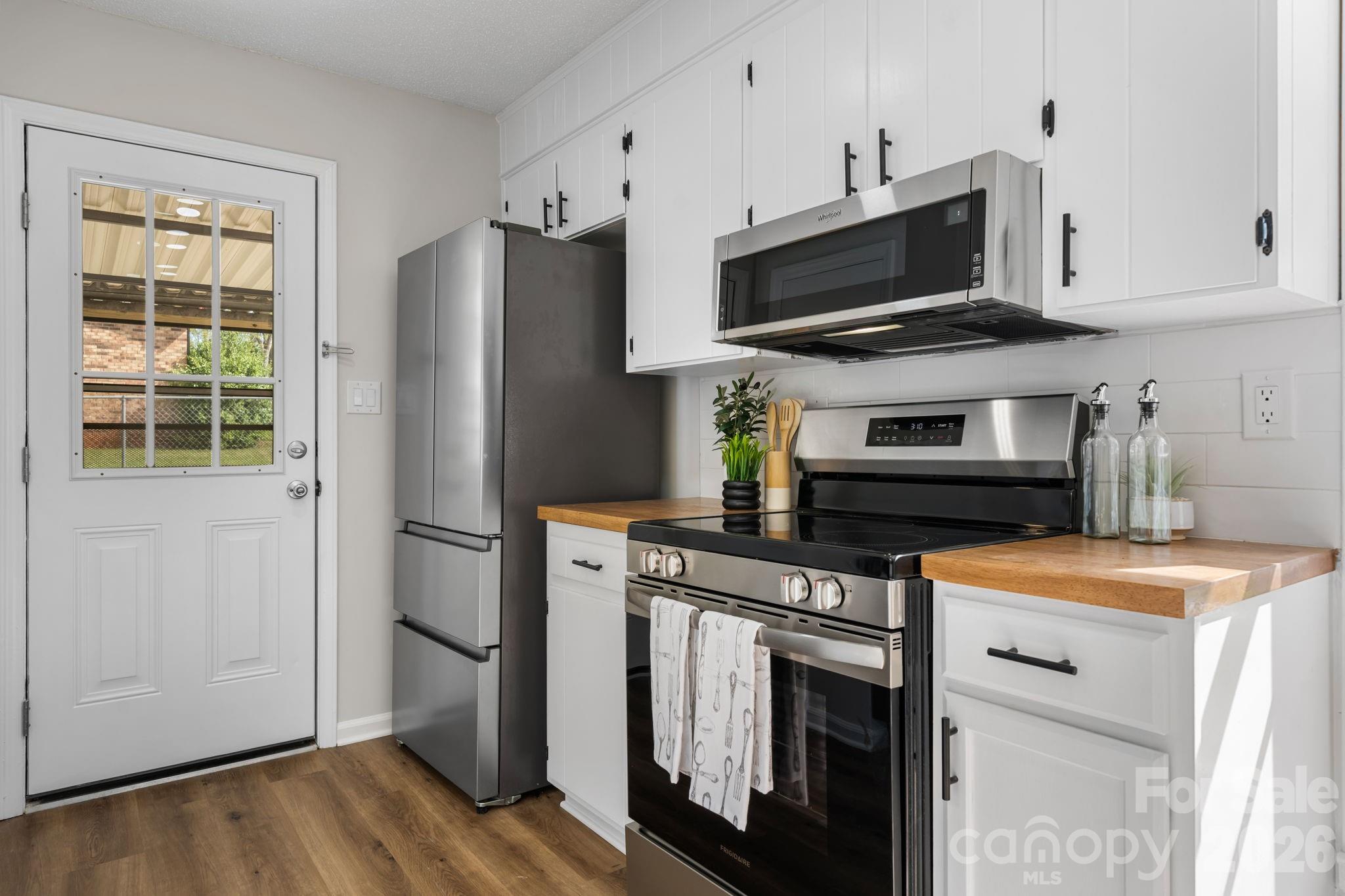 1307 6th Avenue Northwest Conover, NC 28613 - Photo 2 of 17 a kitchen with stainless steel appliances a stove a microwave and sink