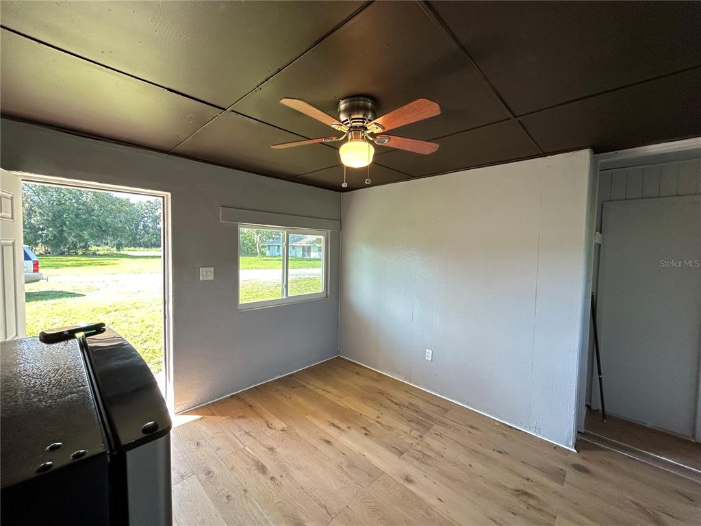 8010 Southeast Us Highway Hawthorne, FL 32640 - Photo 12 of 22 a view of a livingroom with a ceiling fan and a window