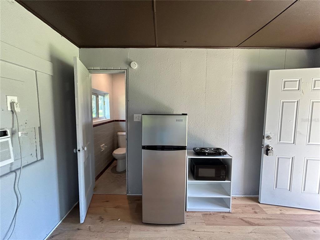 8010 Southeast Us Highway Hawthorne, FL 32640 - Photo 13 of 22 a kitchen with a refrigerator and a stove