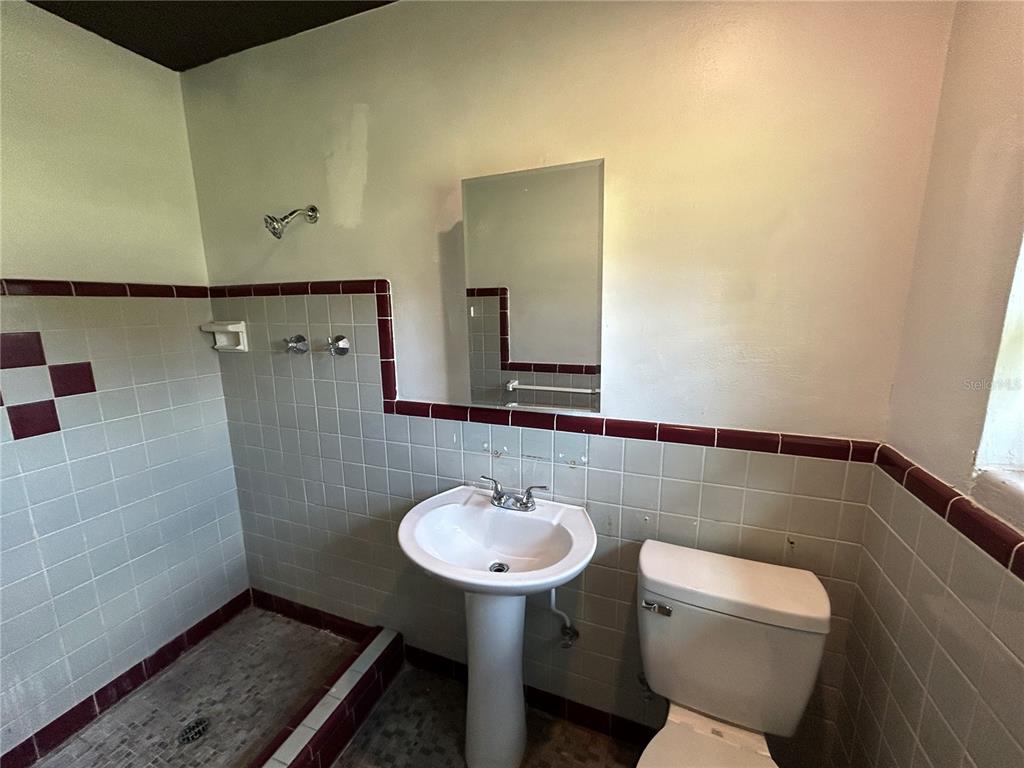 8010 Southeast Us Highway Hawthorne, FL 32640 - Photo 15 of 22 a bathroom with a sink toilet and a mirror