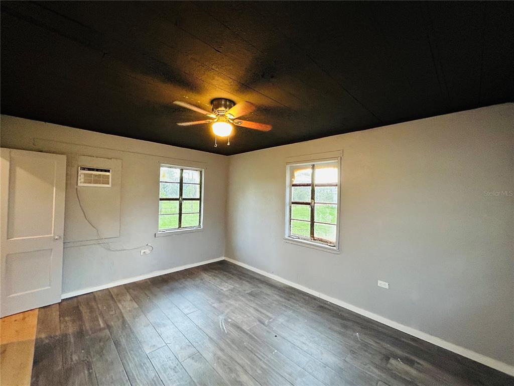 8010 Southeast Us Highway Hawthorne, FL 32640 - Photo 18 of 22 an empty room with wooden floor and windows