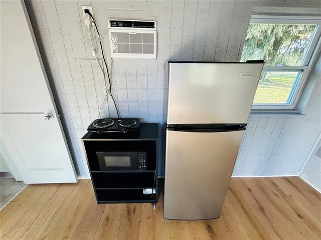 a utility room with wooden floor washer and dryer