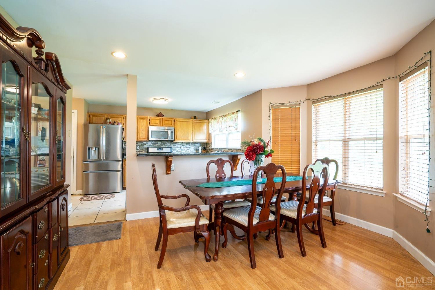 63 Springfield Road North Brunswick, NJ 08902 - Photo 11 of 42 a dining room with furniture and wooden floor