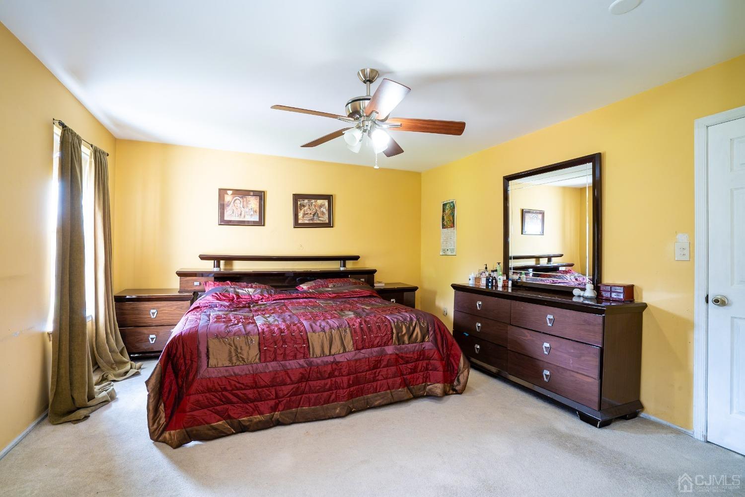 63 Springfield Road North Brunswick, NJ 08902 - Photo 18 of 42 a bedroom with a bed and a chandelier