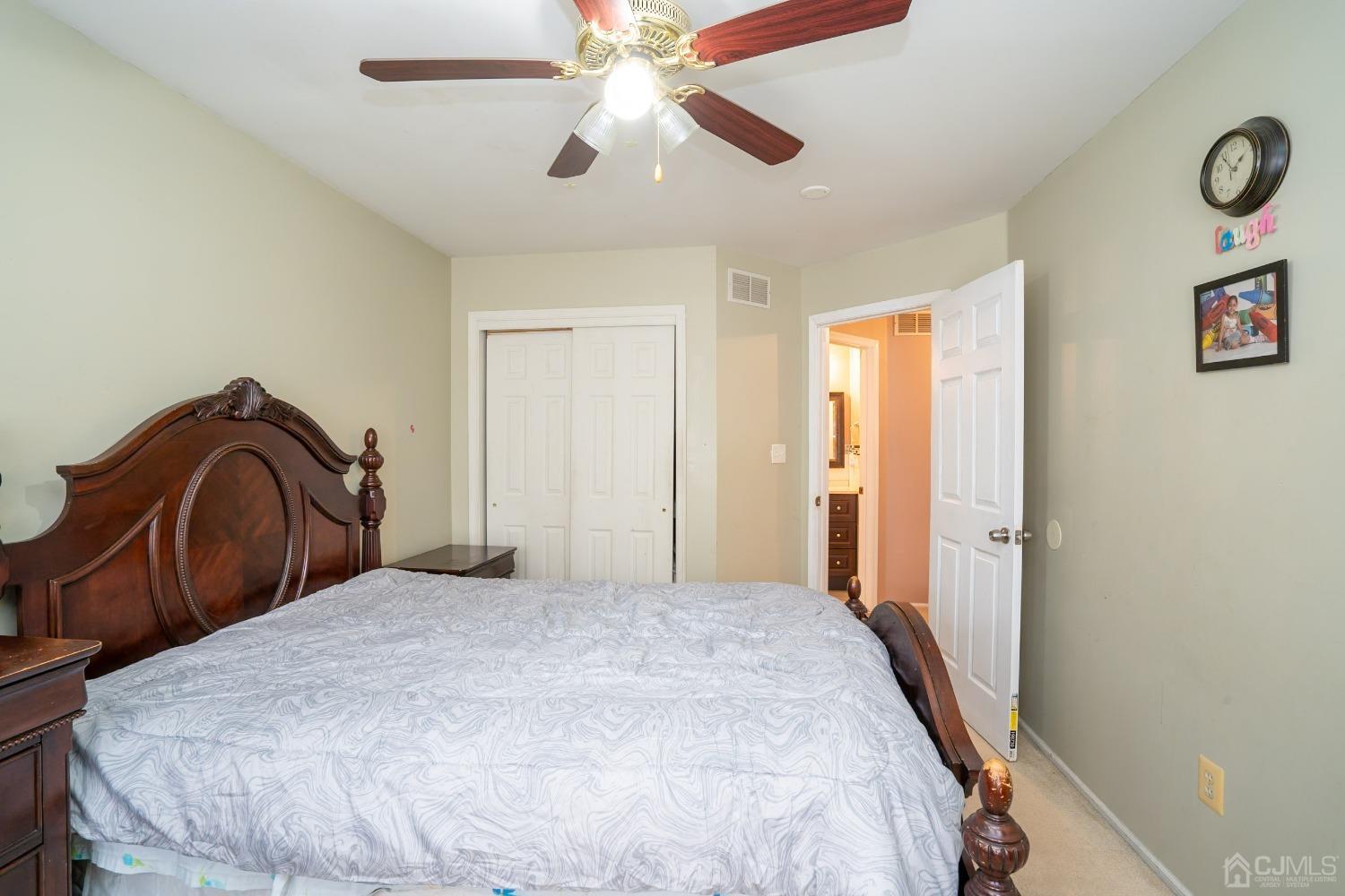 63 Springfield Road North Brunswick, NJ 08902 - Photo 23 of 42 a bedroom with a bed and a chandelier