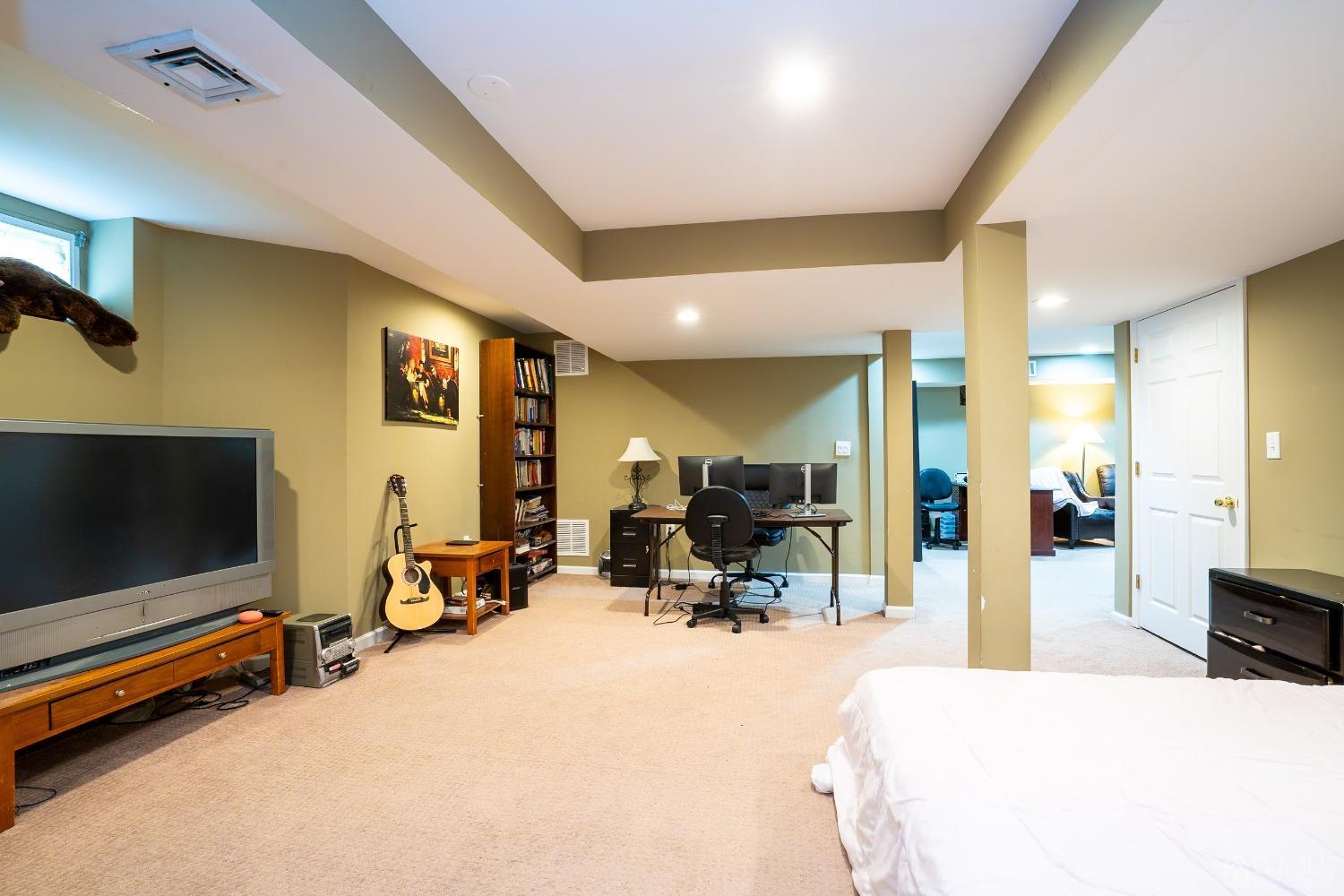 63 Springfield Road North Brunswick, NJ 08902 - Photo 29 of 42 a view of a livingroom with furniture and a flat screen tv