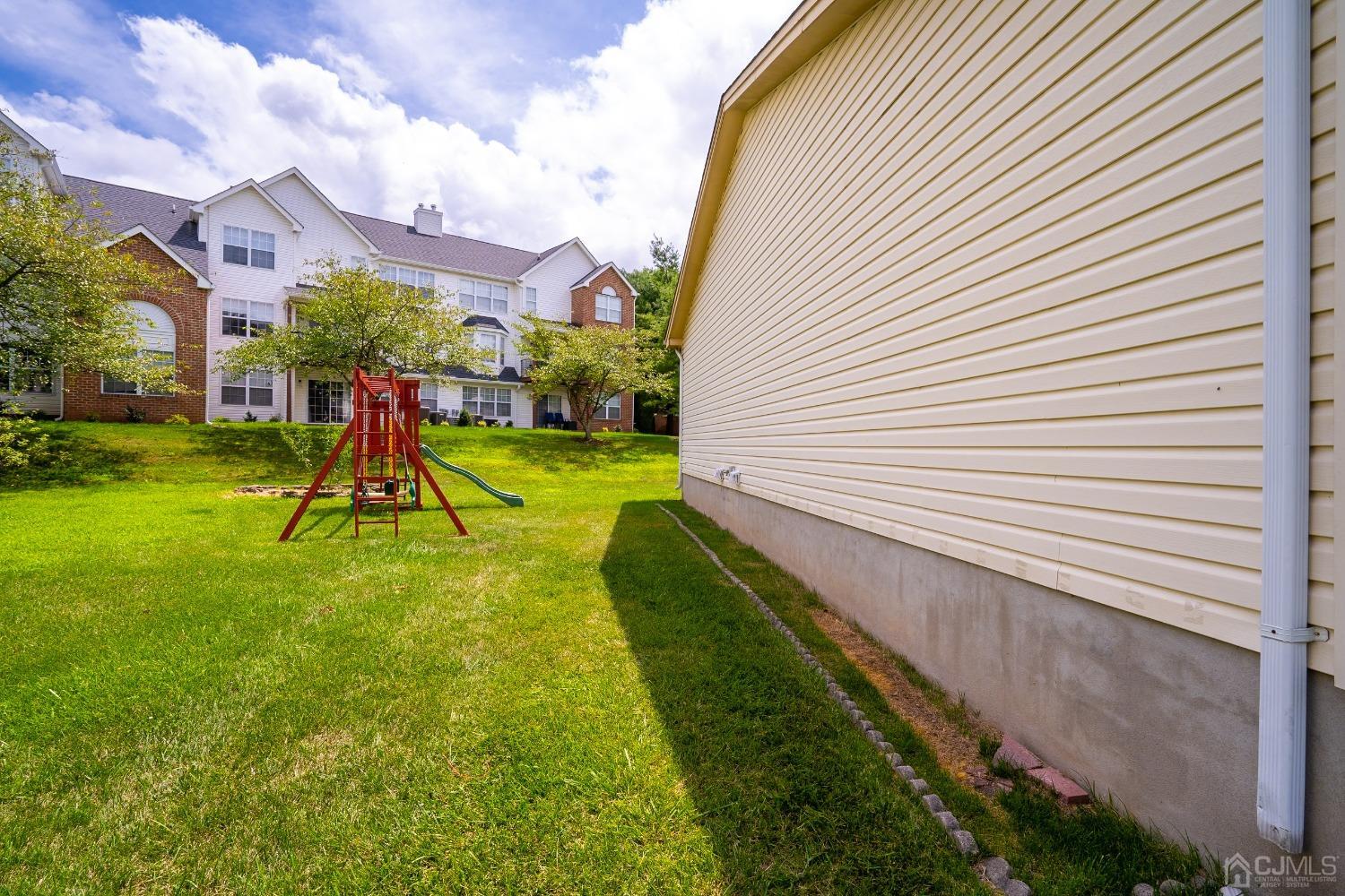 63 Springfield Road North Brunswick, NJ 08902 - Photo 3 of 42 a view of a backyard with a slide