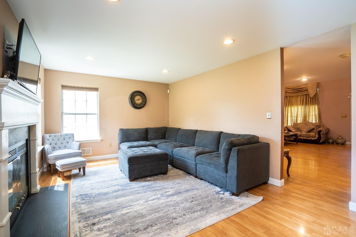 63 Springfield Road North Brunswick, NJ 08902 - Photo 8 of 42 a living room with couches and a flat screen tv with kitchen view