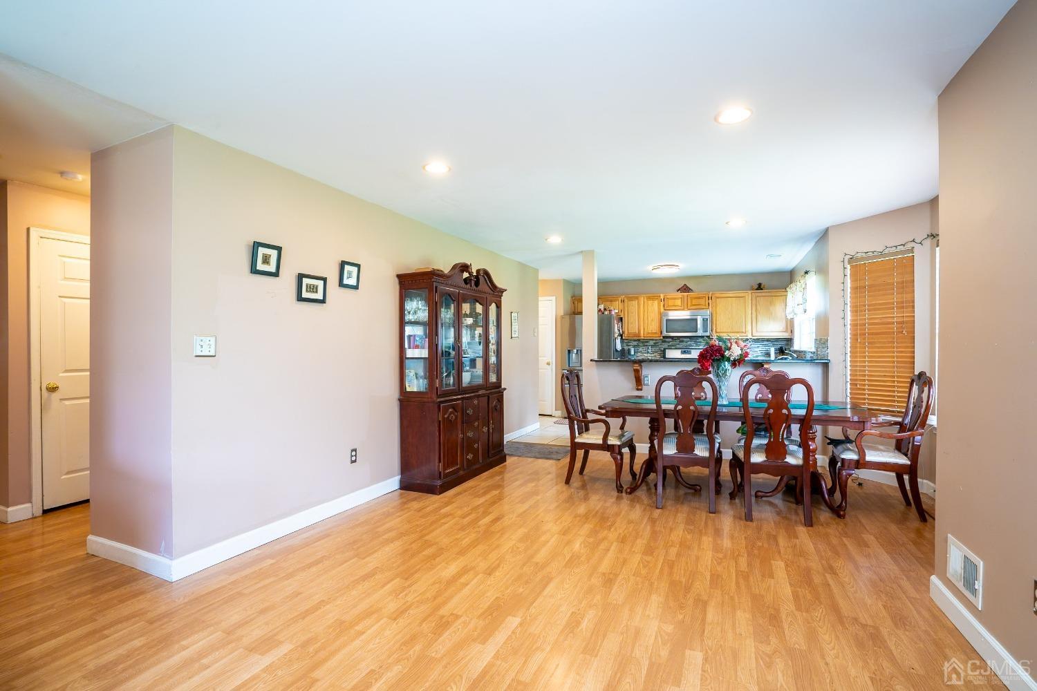 63 Springfield Road North Brunswick, NJ 08902 - Photo 10 of 42 a view of a dining room with furniture and wooden floor