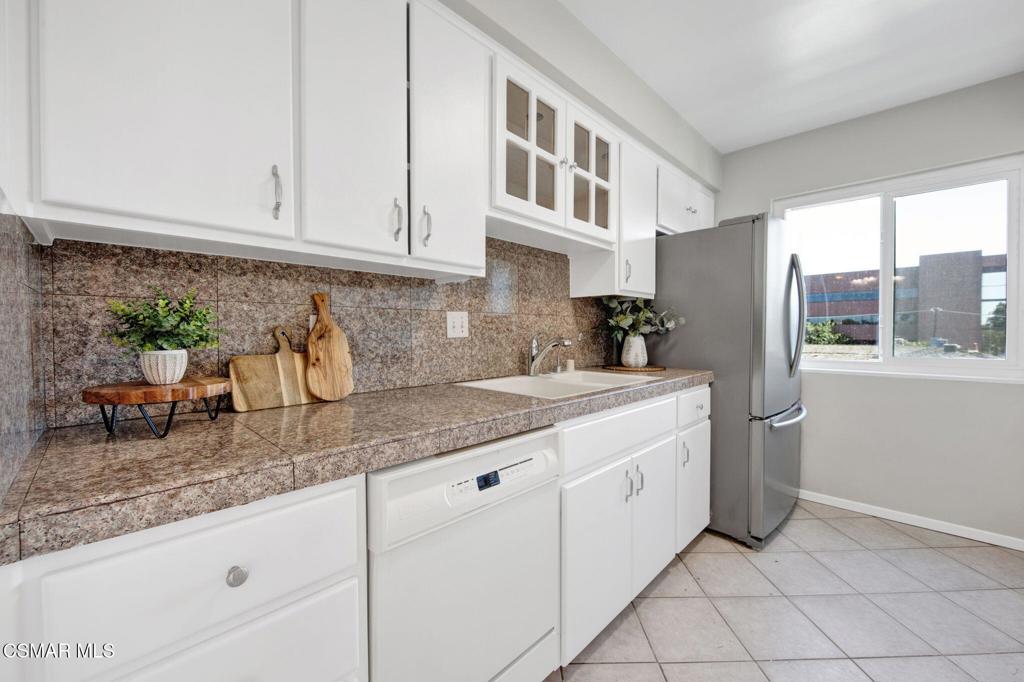 12955 Riverside Drive, Unit 307 Sherman Oaks, CA 91423 - Photo 11 of 24 a kitchen with stainless steel appliances granite countertop a sink and cabinets