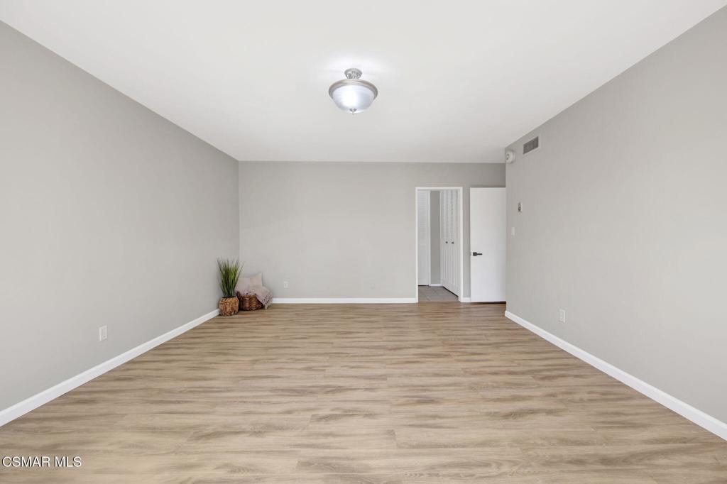 12955 Riverside Drive, Unit 307 Sherman Oaks, CA 91423 - Photo 13 of 24 a view of an empty room with wooden floor and a window