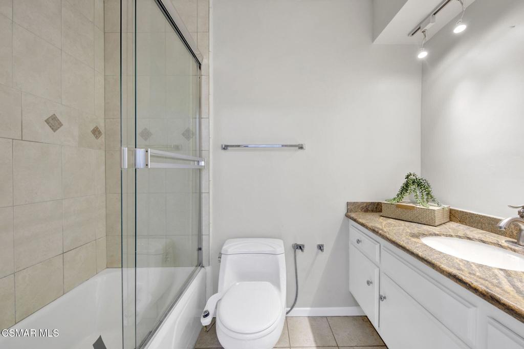12955 Riverside Drive, Unit 307 Sherman Oaks, CA 91423 - Photo 15 of 24 a bathroom with a granite countertop sink a toilet and shower