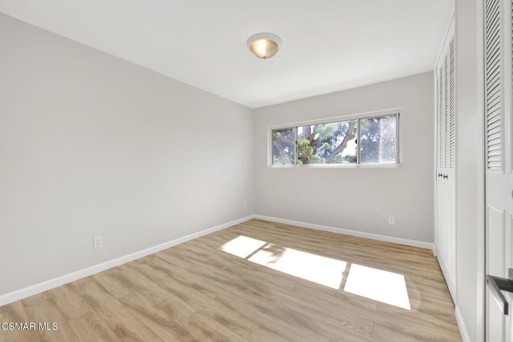12955 Riverside Drive, Unit 307 Sherman Oaks, CA 91423 - Photo 17 of 24 an empty room with wooden floor and windows