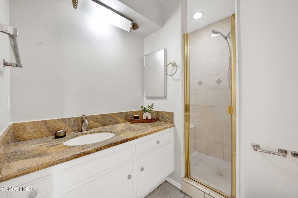 12955 Riverside Drive, Unit 307 Sherman Oaks, CA 91423 - Photo 18 of 24 a bathroom with a granite countertop sink mirror and double