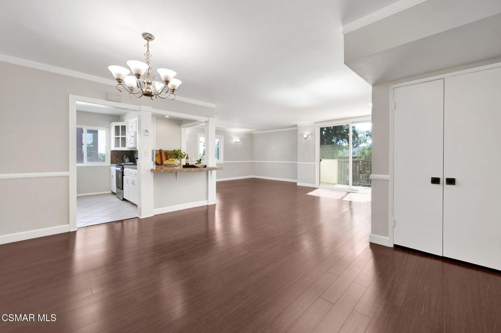 12955 Riverside Drive, Unit 307 Sherman Oaks, CA 91423 - Photo 3 of 24 a view of a room with wooden floor and kitchen view