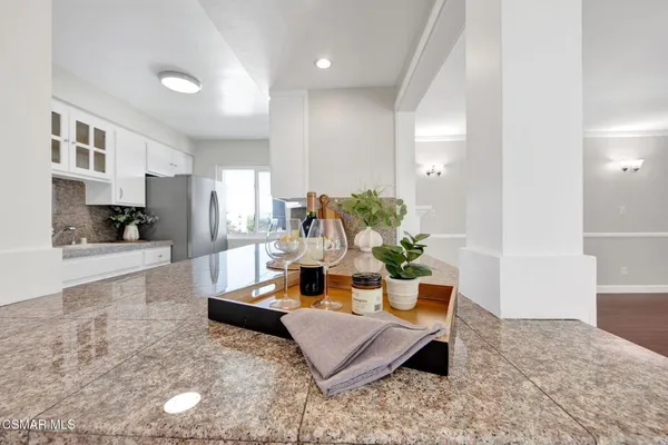 a living room with furniture and a kitchen