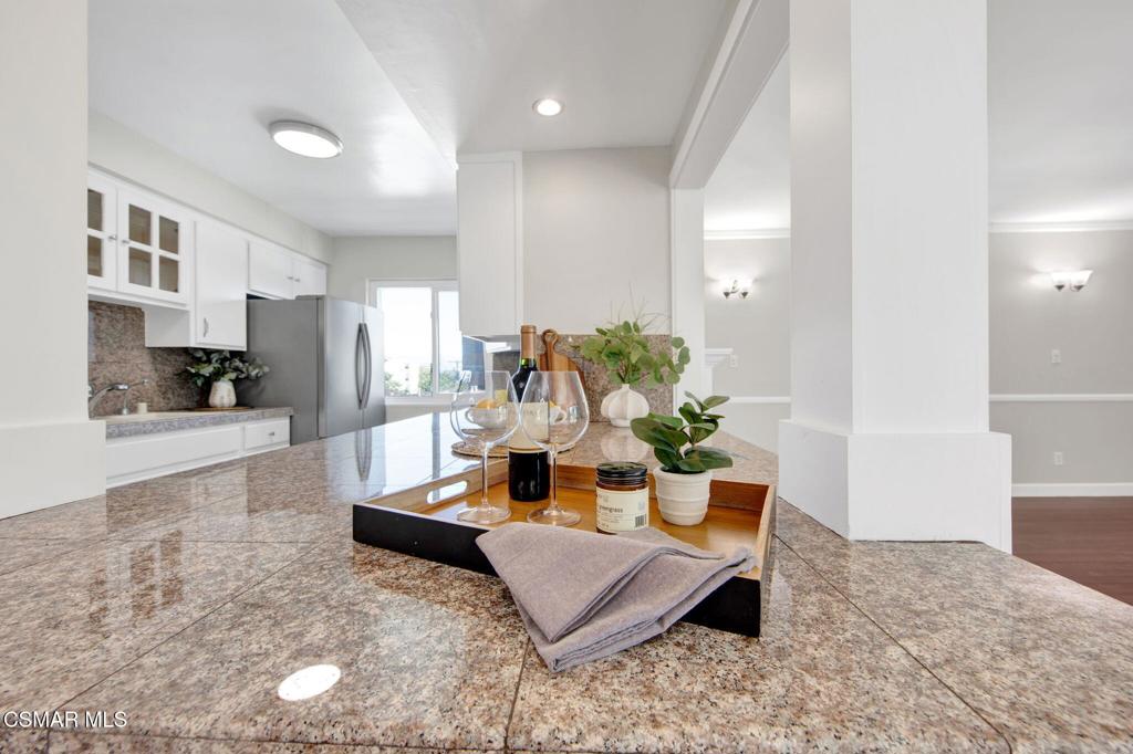12955 Riverside Drive, Unit 307 Sherman Oaks, CA 91423 - Photo 8 of 24 a living room with furniture and a kitchen