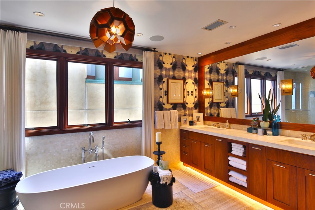 3124 The Strand Hermosa Beach, CA 90254 - Photo 17 of 28 a bathroom with a sink a large mirror and a bathtub