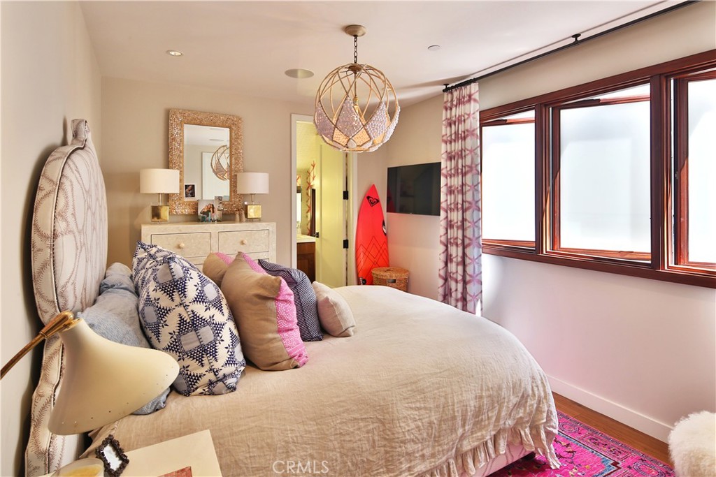 3124 The Strand Hermosa Beach, CA 90254 - Photo 19 of 28 a bedroom with a bed and dresser with mirror