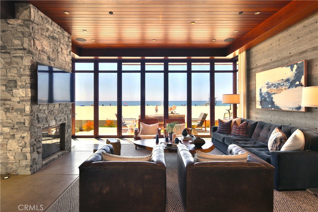 3124 The Strand Hermosa Beach, CA 90254 - Photo 6 of 28 a living room with furniture large windows and a fireplace