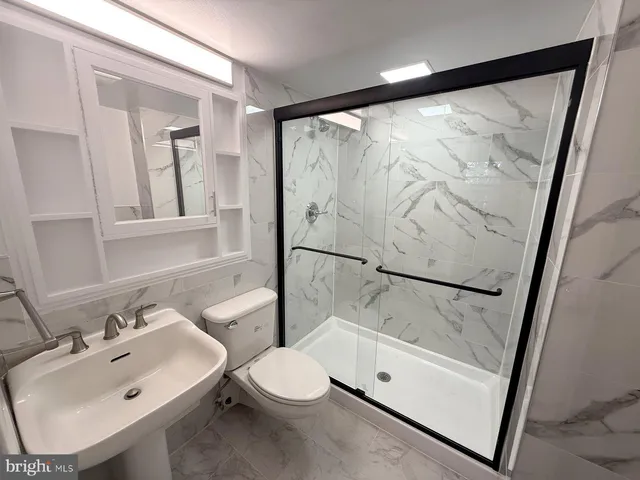 a bathroom with a sink mirror toilet and bathtub