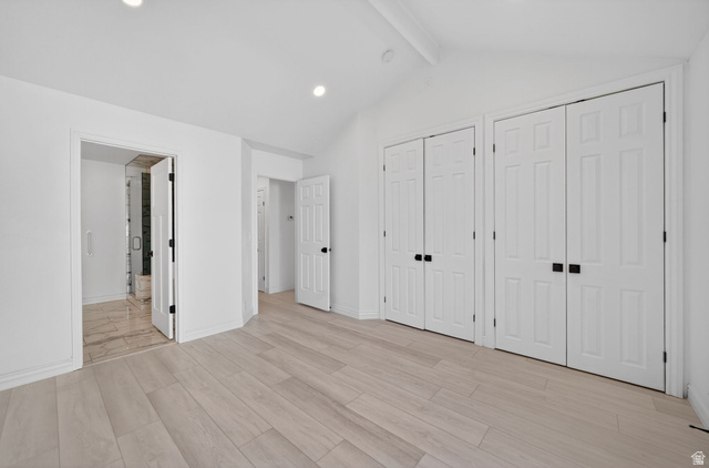 6969 South 855 East Midvale, UT 84047 - Photo 27 of 55 Spacious room featuring light wood-finish flooring, recessed lighting, vaulted ceilings, and white paneled doors with matte black hardware