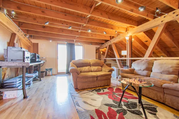 a living room with furniture and a wooden floor