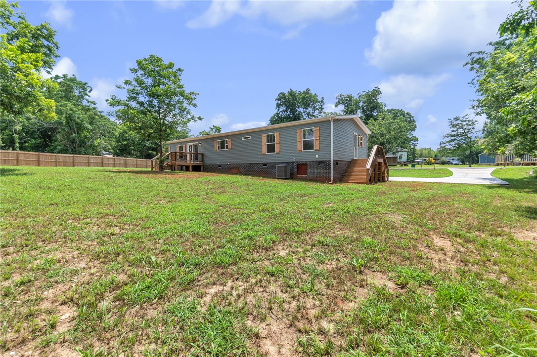 108 Old River Road Iva, SC 29655 - Photo 22 of 31 A sprawling lawn offers abundant space for outdoor activities, complementing the home's casual exterior.