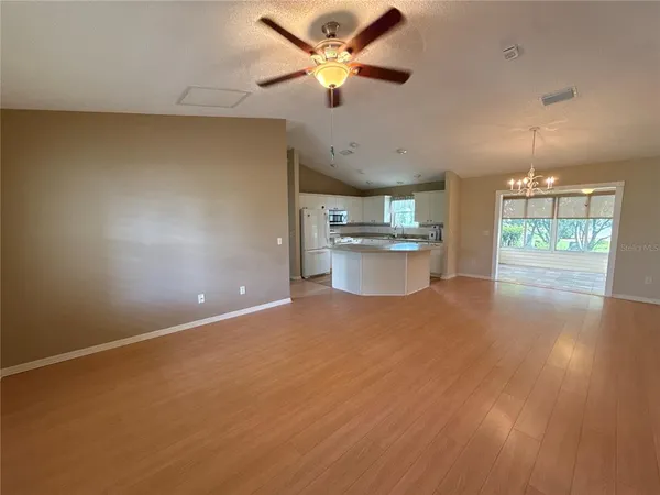 a open kitchen with stove and white cabinets