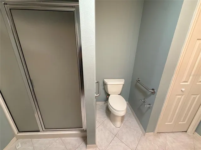 a white toilet sitting next to a sink
