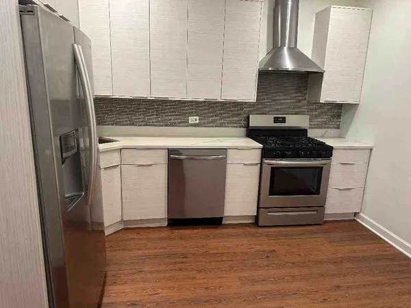 a kitchen with stainless steel appliances a stove and a refrigerator