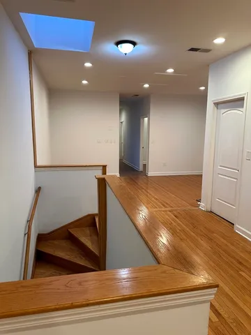 a view of a hallway to an empty room