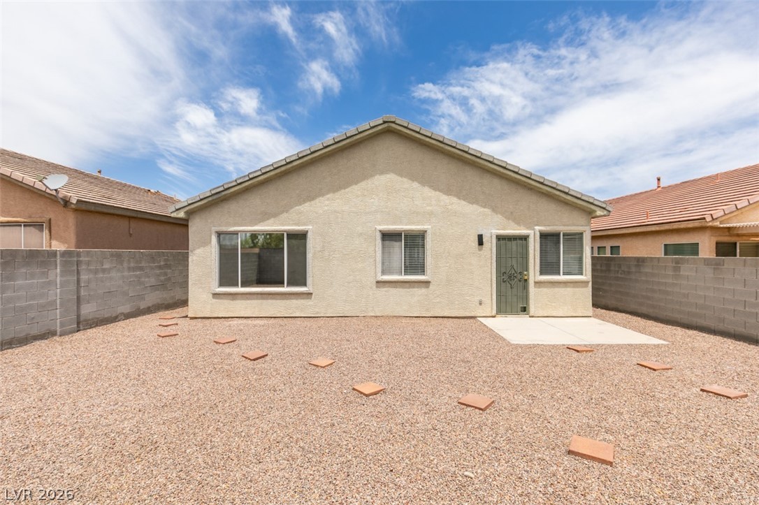 10959 Pumpkin Ridge Avenue Las Vegas, NV 89135 - Photo 36 of 51 Backyard sanctuary features privacy walls and a functional patio space.