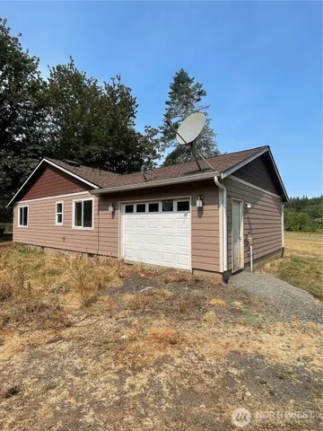 a front view of house with yard and trees