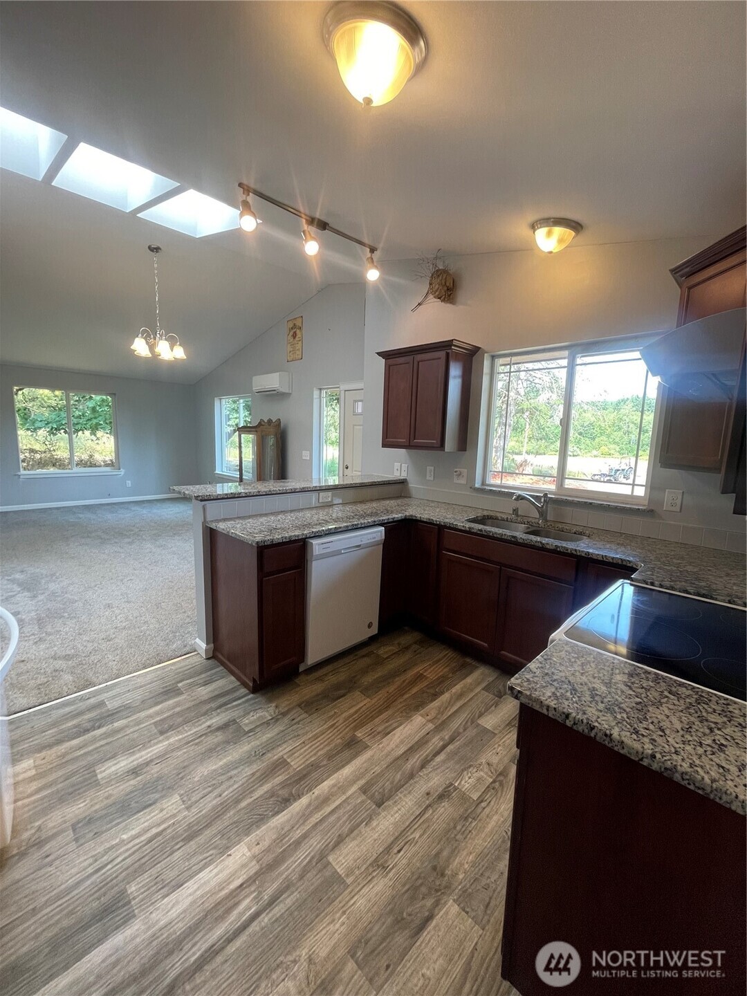 397 Bunker And 0 Bunker Road Chehalis, WA 98532 - Photo 6 of 20 a large kitchen with kitchen island a sink dishwasher stove and oven with wooden floor