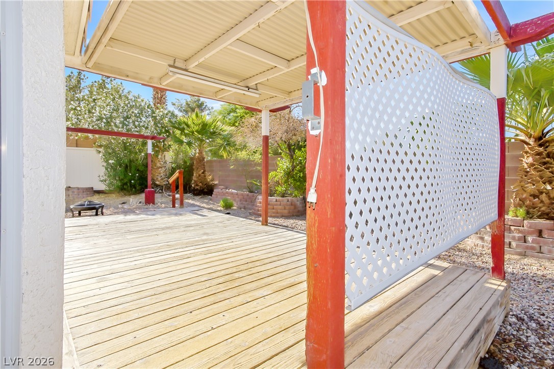 5100 Rancher Avenue Las Vegas, NV 89108 - Photo 13 of 26 An inviting wood deck extends a spacious outdoor living area, perfect for entertaining.
