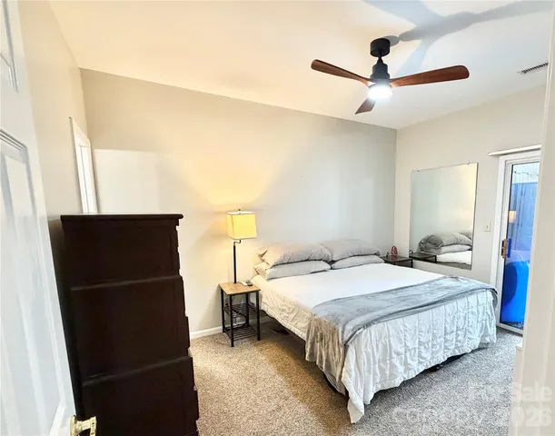 a bedroom with a bed and a ceiling fan