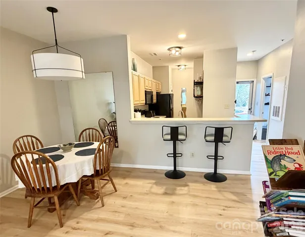 a view of a livingroom with furniture and a kitchen